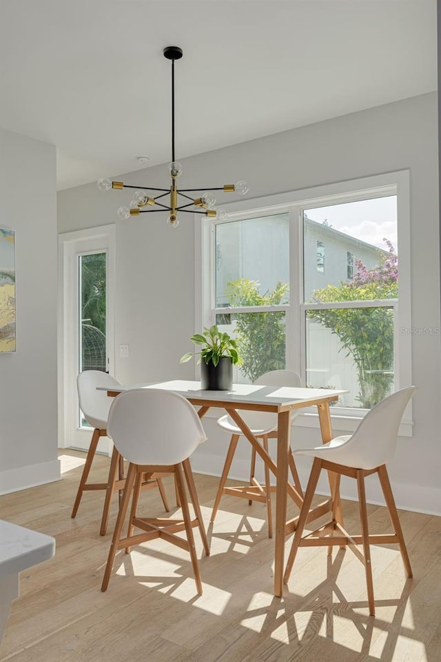 dining space featuring a chandelier and light wood-type flooring