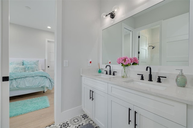 bathroom featuring a shower, tile patterned flooring, and vanity