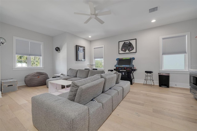 living room with light wood-type flooring and ceiling fan