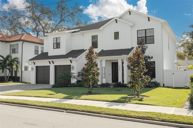 modern farmhouse style home featuring a front lawn and a garage