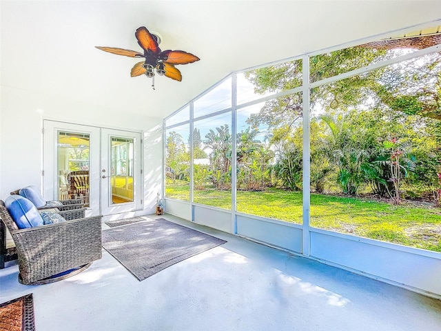 unfurnished sunroom featuring ceiling fan, french doors, and vaulted ceiling