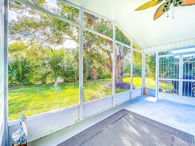 unfurnished sunroom with a healthy amount of sunlight and lofted ceiling