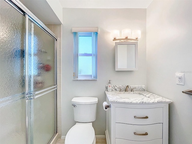 bathroom with vanity, an enclosed shower, and toilet