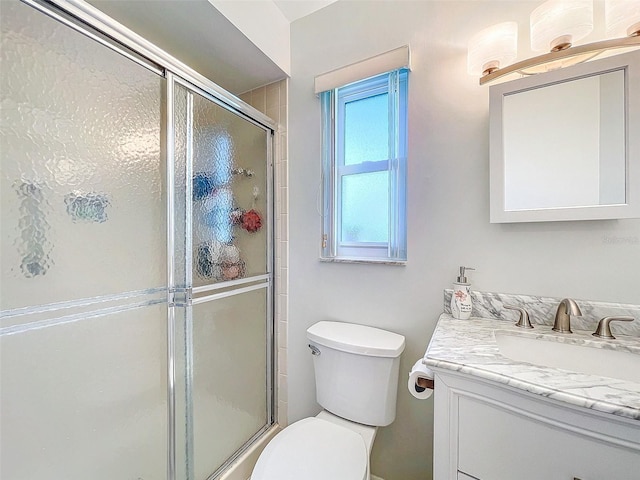 bathroom featuring vanity, plenty of natural light, and an enclosed shower