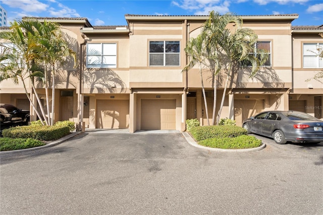 multi unit property featuring a garage