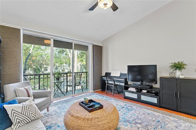 living room featuring hardwood / wood-style floors, ceiling fan, and vaulted ceiling