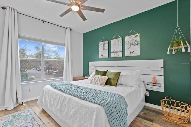 bedroom featuring hardwood / wood-style flooring and ceiling fan