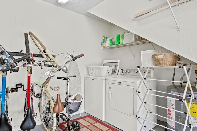 washroom featuring washing machine and clothes dryer and water heater