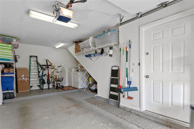 garage featuring washer and clothes dryer and a garage door opener