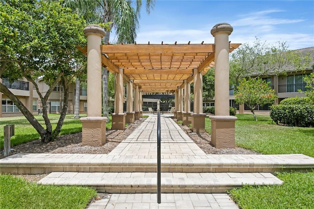 view of property's community featuring a pergola and a yard