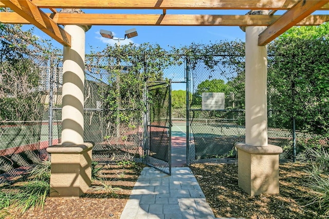 view of patio / terrace featuring tennis court and a pergola