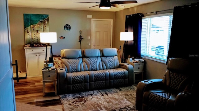 living room with ceiling fan and light wood-type flooring