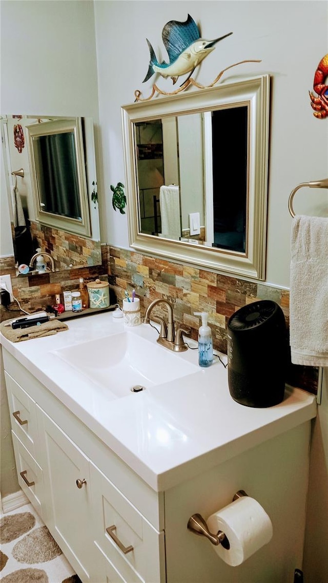 bathroom with decorative backsplash and vanity