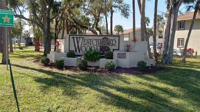 community / neighborhood sign with a yard