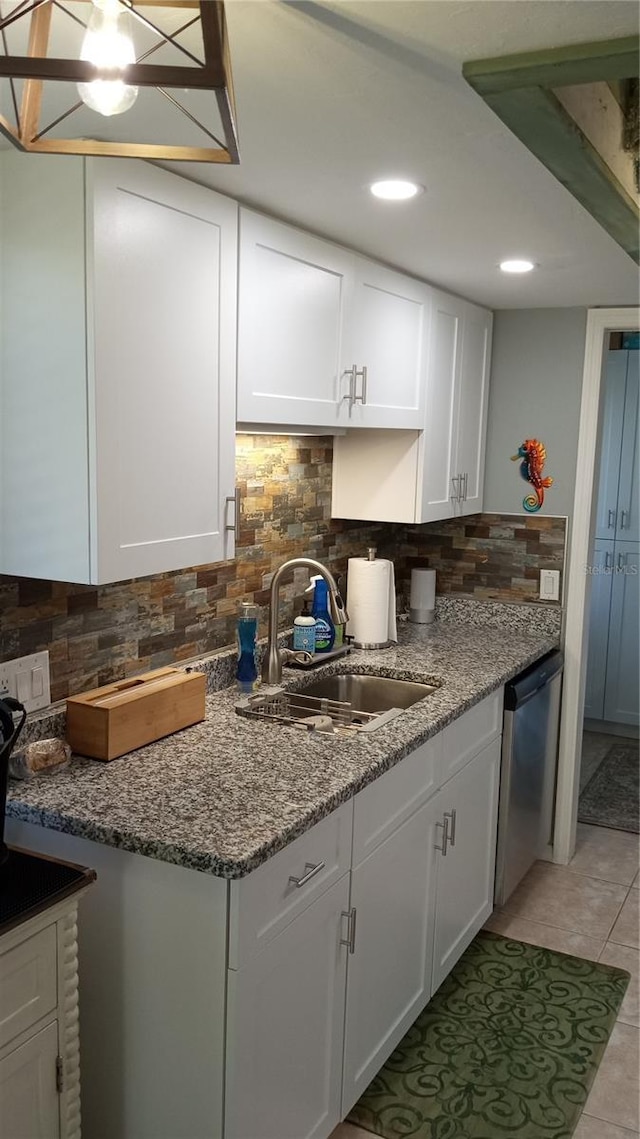 kitchen with white cabinets, stainless steel dishwasher, and sink