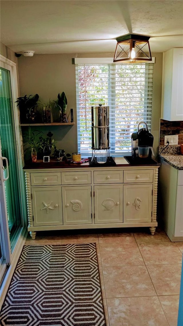 kitchen with light tile patterned flooring