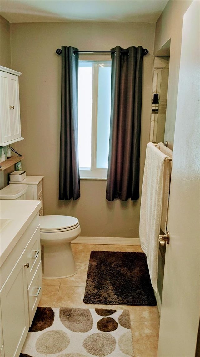 bathroom featuring tile patterned floors, vanity, and toilet