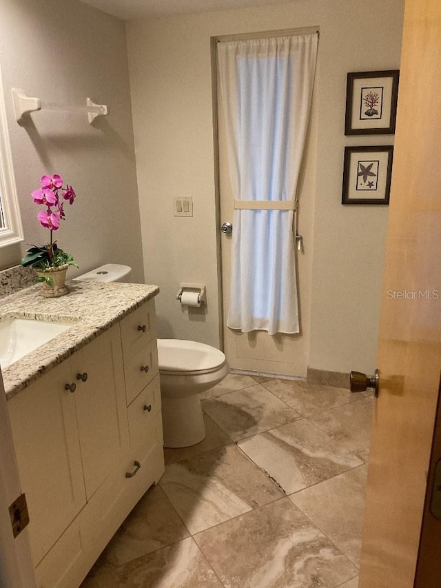 bathroom with toilet and vanity