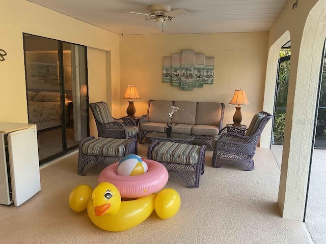 living room featuring light carpet and ceiling fan