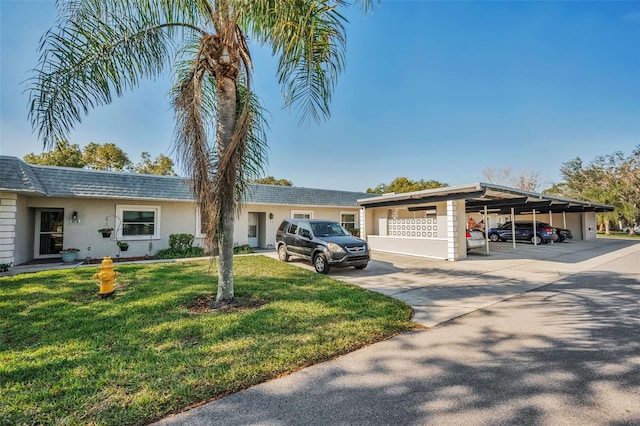 ranch-style home featuring a front yard and a carport