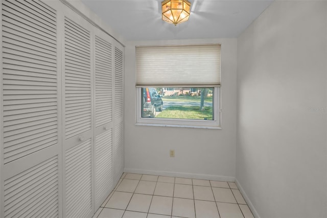 interior space featuring light tile patterned floors and a closet