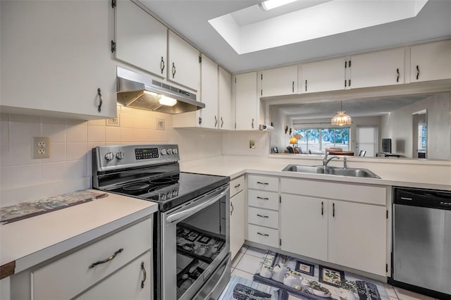 kitchen featuring white cabinets, sink, hanging light fixtures, tasteful backsplash, and stainless steel appliances