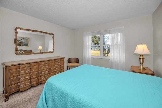 carpeted bedroom featuring a textured ceiling