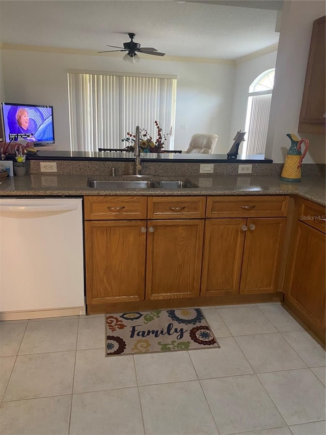 kitchen featuring dishwasher, light tile patterned flooring, ceiling fan, and sink