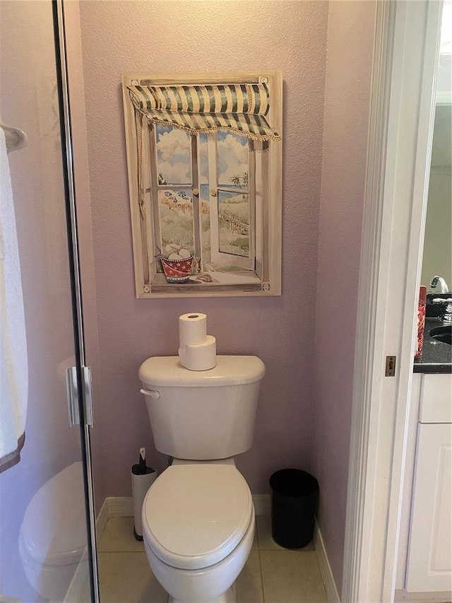 bathroom featuring tile patterned floors and toilet