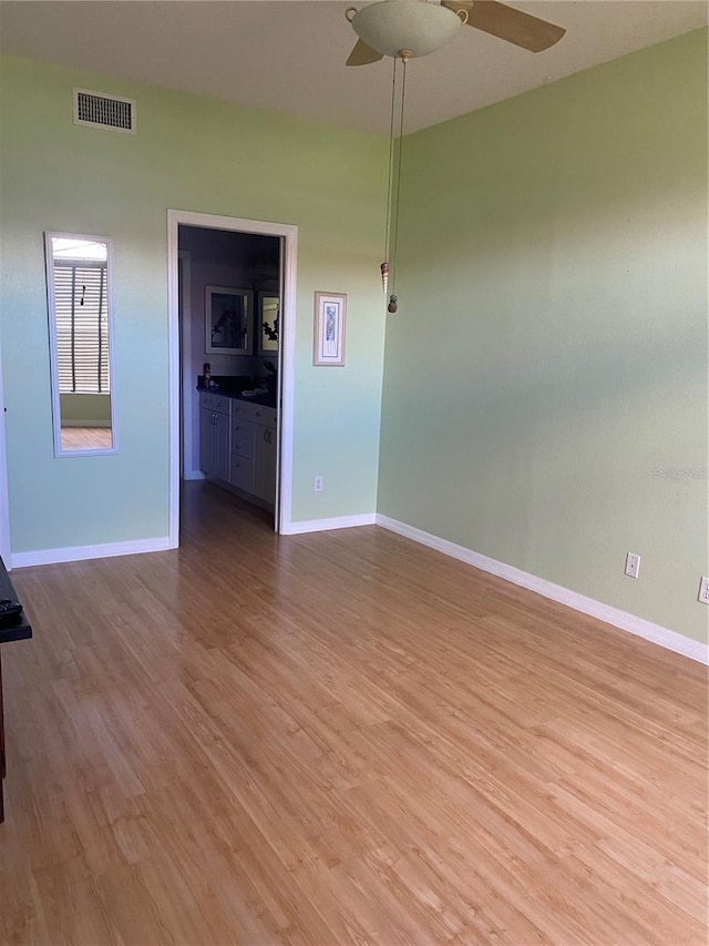 unfurnished room featuring hardwood / wood-style floors and ceiling fan