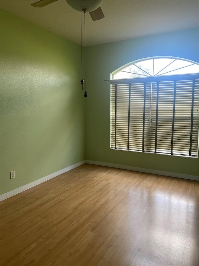 unfurnished room featuring hardwood / wood-style flooring and ceiling fan