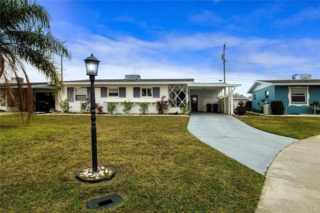 ranch-style house featuring a front lawn and a carport