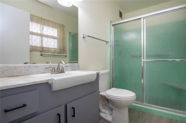 bathroom with vanity, toilet, and walk in shower