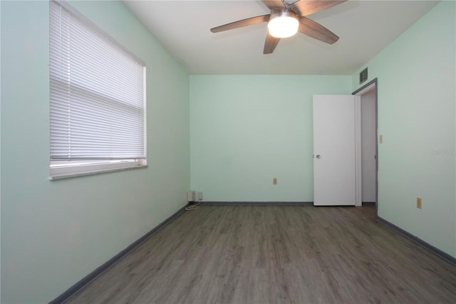 empty room featuring dark hardwood / wood-style floors and ceiling fan