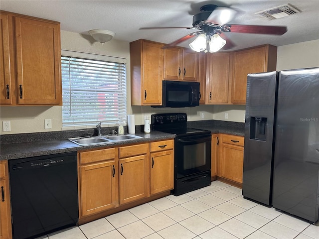 kitchen featuring black appliances, sink, ceiling fan, light tile patterned floors, and a textured ceiling