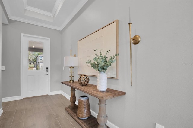 entrance foyer featuring crown molding and light hardwood / wood-style flooring