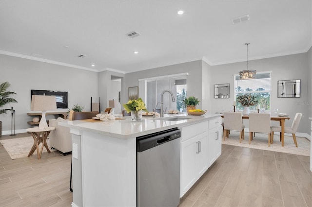 kitchen featuring white cabinets, sink, a center island with sink, dishwasher, and hanging light fixtures