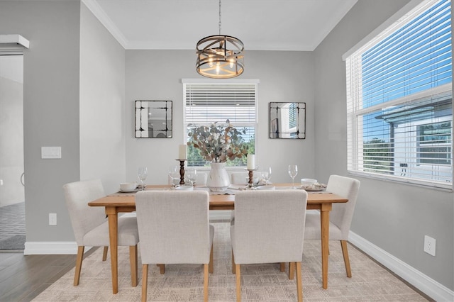 dining room with a chandelier, hardwood / wood-style floors, and ornamental molding