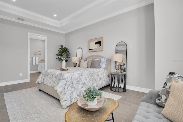 bedroom with a raised ceiling and crown molding