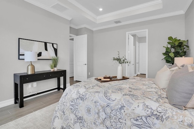 bedroom with a tray ceiling and crown molding