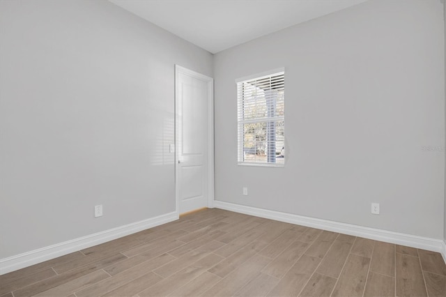 unfurnished room with light wood-type flooring