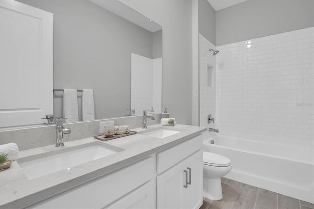 full bathroom featuring vanity, toilet, and tiled shower / bath