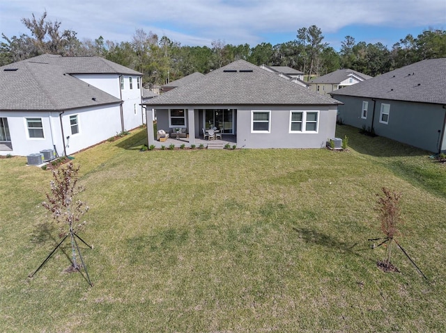 rear view of property featuring a yard, a patio, and cooling unit