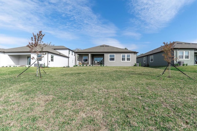 back of house with a yard