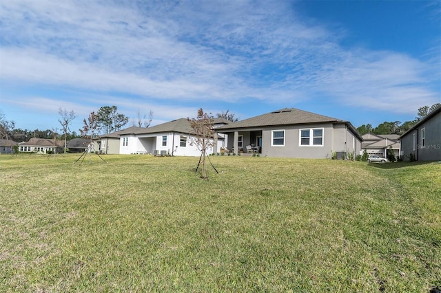 rear view of house with a yard