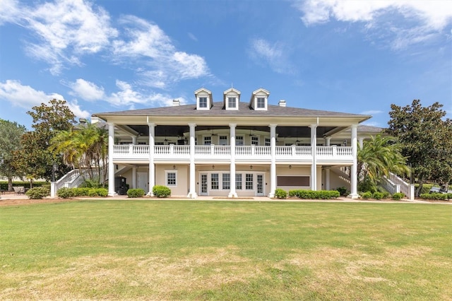 back of property featuring a lawn and french doors