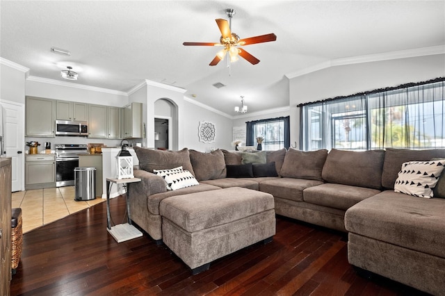 living room featuring ornamental molding, ceiling fan with notable chandelier, a textured ceiling, wood-type flooring, and lofted ceiling