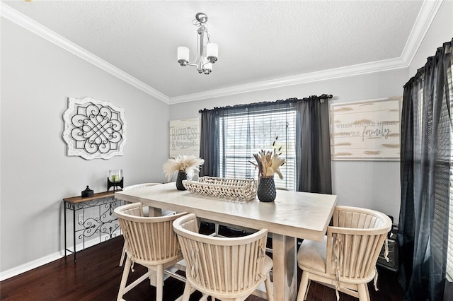 dining area featuring a notable chandelier, crown molding, a textured ceiling, and dark wood-type flooring