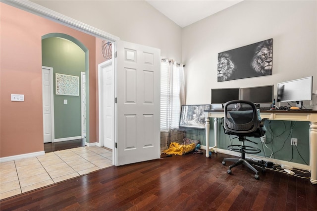 office space featuring hardwood / wood-style floors and vaulted ceiling