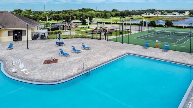 view of swimming pool with tennis court